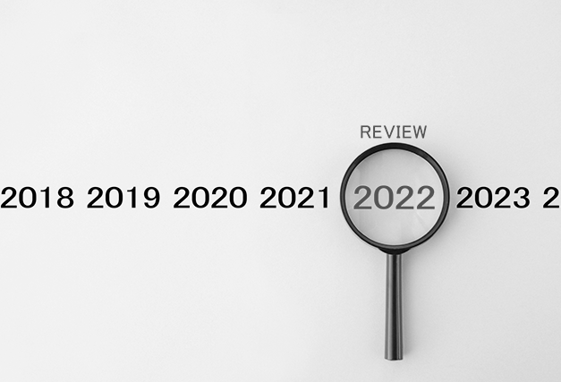 years 2020 through 2023 listed on a blue background with a magnifying glass over 2022