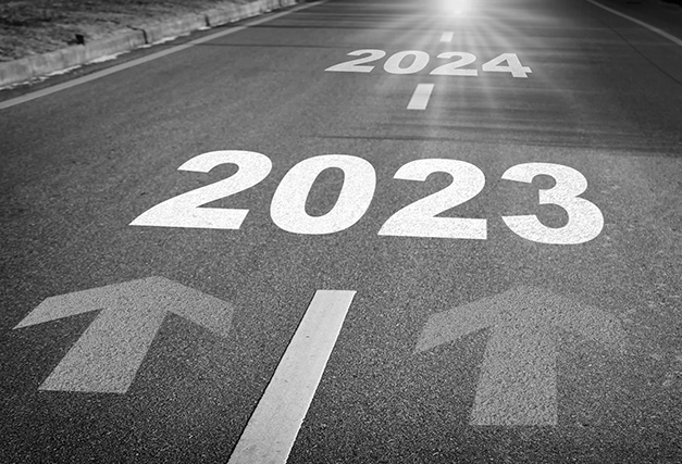 a road with 2023 and two arrows printed on it
